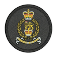 Circular military patch with a crown and laurel wreath design on a black background