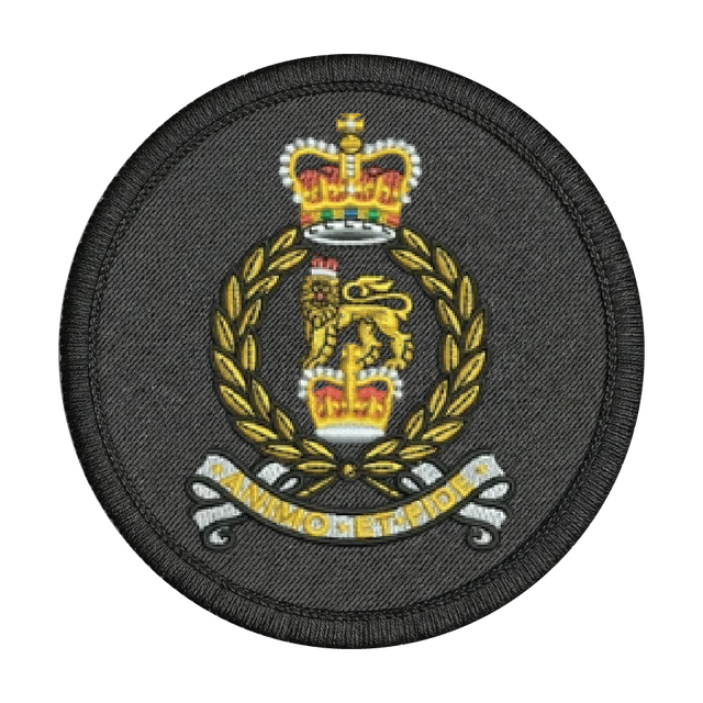 Circular military patch with a crown and laurel wreath design on a black background