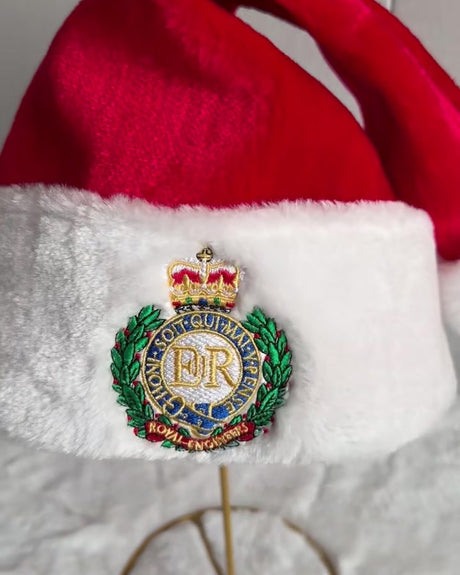 Close up of the embroidered Royal Engineers cap badge on the Santa hat